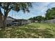 Large backyard featuring a spacious lawn, mature trees, and plenty of room to relax at 2430 Westwood Dr, Longwood, FL 32779