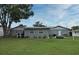 Spacious backyard featuring a well-maintained lawn, mature trees, and inviting patio area at 2430 Westwood Dr, Longwood, FL 32779
