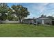 Spacious backyard with lush lawn and patio featuring an inflatable hot tub, ideal for gatherings at 2430 Westwood Dr, Longwood, FL 32779