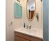 Bright bathroom featuring a modern sink, unique mirror, and stylish shuttered cabinet at 2430 Westwood Dr, Longwood, FL 32779