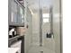 Modern bathroom with stand up shower, tiled floor and wall-mounted shelves at 2430 Westwood Dr, Longwood, FL 32779