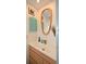 Bright bathroom featuring a modern sink, unique mirror, and stylish shuttered cabinet at 2430 Westwood Dr, Longwood, FL 32779