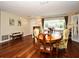 Dining room features hardwood floors, a dining table with seating, and natural light from large windows, perfect for gatherings at 2430 Westwood Dr, Longwood, FL 32779