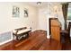 Inviting entryway with hardwood floors, a decorative bench, and a view of the staircase, creating a warm welcome at 2430 Westwood Dr, Longwood, FL 32779