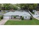 This home features manicured lawn, gray painted brick, white trim, attached garage, and mature trees on a shaded lot at 2430 Westwood Dr, Longwood, FL 32779