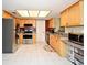 Open kitchen featuring stainless steel appliances, light wood cabinets, and a bright, tiled floor at 2430 Westwood Dr, Longwood, FL 32779