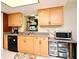 Bright kitchen with wooden cabinets, black appliances, and tiled floors at 2430 Westwood Dr, Longwood, FL 32779