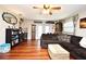 Open living area with wood floors, dark sofa, ceiling fan, and stylish decor at 2430 Westwood Dr, Longwood, FL 32779
