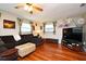 Cozy living room with hardwood floors, a comfortable sectional, and decorative tropical curtains at 2430 Westwood Dr, Longwood, FL 32779