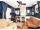 Functional home office with hardwood floors, a futon, and a multi-monitor setup at 2430 Westwood Dr, Longwood, FL 32779