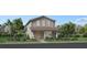 Charming two-story home features a covered front porch, landscaped yard, and classic architectural details at 2551 Long Pine Ave, Apopka, FL 32712