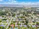 Expansive aerial view of a charming neighborhood with lush greenery and city skyline in the distance at 2932 Carriage Dr, South Daytona, FL 32119