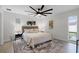 Bedroom features neutral decor, a large rug, and a modern ceiling fan, creating a cozy and stylish retreat at 2932 Carriage Dr, South Daytona, FL 32119