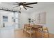 Dining room featuring a modern light fixture, wooden table with chairs, and sliding barn doors to another room at 2932 Carriage Dr, South Daytona, FL 32119