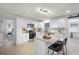 Well-lit kitchen featuring white cabinets, stainless steel appliances, granite countertops and modern island seating at 2932 Carriage Dr, South Daytona, FL 32119