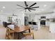 Open-concept kitchen and dining area with stainless steel appliances, granite countertops, and a view into the living room at 2932 Carriage Dr, South Daytona, FL 32119