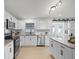 Updated kitchen with granite countertops, stainless steel appliances, and a sliding barn door to an adjacent room at 2932 Carriage Dr, South Daytona, FL 32119