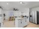 Open-concept kitchen with granite countertops, a center island, and views of the dining and living areas at 2932 Carriage Dr, South Daytona, FL 32119
