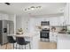 Updated kitchen boasts stainless steel appliances, granite countertops, a center island with bar seating, and track lighting at 2932 Carriage Dr, South Daytona, FL 32119