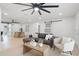Spacious living area with an open floor plan, modern furnishings, and seamless access to the dining area and kitchen at 2932 Carriage Dr, South Daytona, FL 32119
