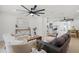 Open-concept living area featuring modern furniture, light wood floors, and seamless flow to the kitchen at 2932 Carriage Dr, South Daytona, FL 32119