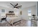 Serene main bedroom featuring a plush bed, stylish decor, a ceiling fan and ample natural light at 2932 Carriage Dr, South Daytona, FL 32119
