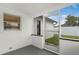 Enclosed porch showcasing white brick walls, windows, and a screen door leading to the backyard at 2932 Carriage Dr, South Daytona, FL 32119