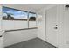 Enclosed porch featuring white walls, a screen window, and a door to the exterior at 2932 Carriage Dr, South Daytona, FL 32119