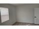 Well-lit bedroom with wood-look floors and window with horizontal blinds at 311 Osceola Ave, Lake Wales, FL 33853