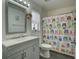 Bright bathroom with a single vanity and an owl-themed shower curtain at 5123 Pineland Ave, Port Orange, FL 32127