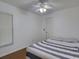 Cozy bedroom featuring a ceiling fan and wood flooring at 5123 Pineland Ave, Port Orange, FL 32127