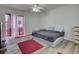 This bedroom includes a large window, and neutral colored walls at 5123 Pineland Ave, Port Orange, FL 32127
