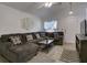 Cozy living room with vaulted ceiling, plush sectional sofa, and stylish decor, perfect for relaxation at 5123 Pineland Ave, Port Orange, FL 32127