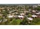 Sprawling aerial view of a residential community nestled amidst lush greenery and mature trees with ample parking and green spaces at 5365 Elm Ct # 331, Orlando, FL 32811