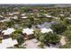 A serene aerial shot showcases a pond surrounded by townhomes in a lush, tree-filled community at 5365 Elm Ct # 331, Orlando, FL 32811