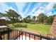 Scenic backyard view, showcasing lush green lawns and mature trees, as seen from a private balcony at 5365 Elm Ct # 331, Orlando, FL 32811
