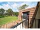 Balcony view overlooking the property and lush green lawns, framed by blue skies and mature trees at 5365 Elm Ct # 331, Orlando, FL 32811