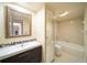 Well-lit bathroom featuring a single vanity, decorative mirror, and shower-tub combination at 5365 Elm Ct # 331, Orlando, FL 32811