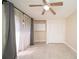 Well-lit bedroom showcasing tiled floors, a ceiling fan, sliding glass doors and storage cabinets at 5365 Elm Ct # 331, Orlando, FL 32811