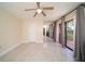 Spacious bedroom featuring tile floors, ceiling fan, sliding glass doors and large mirrored closets at 5365 Elm Ct # 331, Orlando, FL 32811