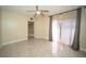 Well-lit bedroom showcasing tile floors, a ceiling fan, sliding glass doors leading to a balcony at 5365 Elm Ct # 331, Orlando, FL 32811