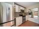 Modern kitchen with stainless steel appliances, granite counters and sleek white cabinetry at 5365 Elm Ct # 331, Orlando, FL 32811