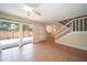 Open-concept living room featuring tile flooring, sliding door to the patio, and a staircase at 5365 Elm Ct # 331, Orlando, FL 32811