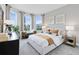 Inviting bedroom with multiple windows offering natural light, complemented by a cozy sitting area and stylish decor at 6015 Tree Crossing Ln, St Cloud, FL 34771