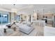 Bright living room with a large sectional sofa, pendant lighting, and access to the outdoor space through sliding glass doors at 6015 Tree Crossing Ln, St Cloud, FL 34771