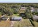 Aerial view of a home with a spacious, fenced-in backyard surrounded by mature trees at 611 S Montgomery Ave, Deland, FL 32720