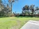 Spacious backyard with healthy green grass, mature trees, and a modern wooden fence at 611 S Montgomery Ave, Deland, FL 32720