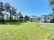Large backyard with green grass, a modern fence, and access to both entrances at 611 S Montgomery Ave, Deland, FL 32720
