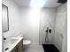 Modern bathroom featuring a walk-in shower with black fixtures and a marble vanity at 611 S Montgomery Ave, Deland, FL 32720