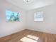 An empty bedroom filled with natural light from two windows and hardwood floors at 611 S Montgomery Ave, Deland, FL 32720